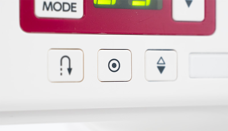 Janome DC1000 Stitch Lock-Off Button